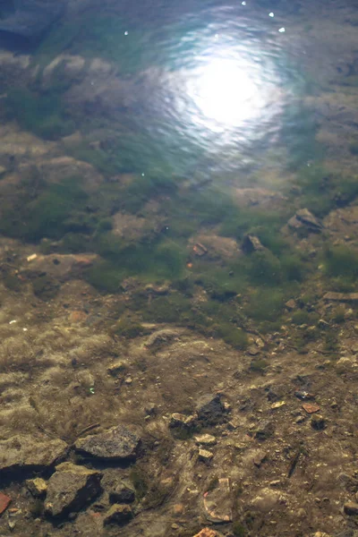 Stream in nature with the ruins of buildings and waste. Flooded building materials after the flood. Background with water for design