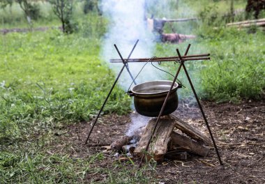 Doğanın arka planında şenlik ateşi ve bowlingci. Yaz kampı parkta ya da dışarıda.