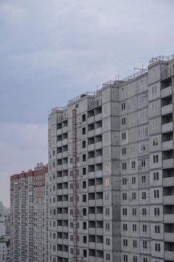 Mavi gökyüzünün arka planında büyük bir inşaat alanı. Brick, apartman dairesi. Tasarım için sanayi teması