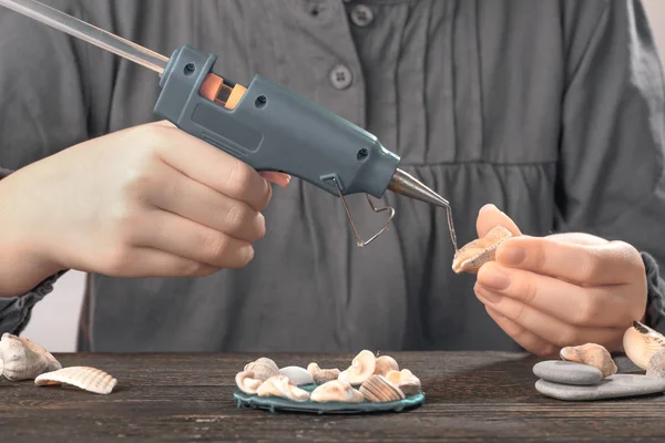 Hobby concept baby hands close up with glue gun. — Stock Photo, Image