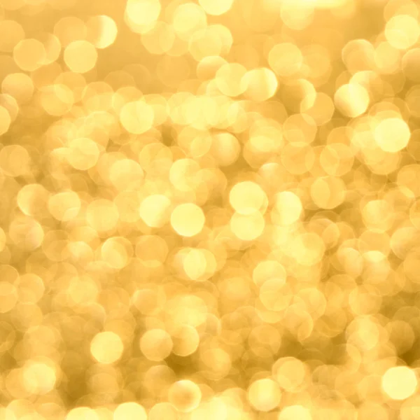 The Golden glow of Bokeh . Abstract blurred glowing background.