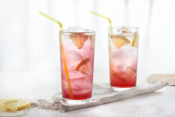 Homemade lemonade in glasses on white background in blur. — Stock Photo, Image