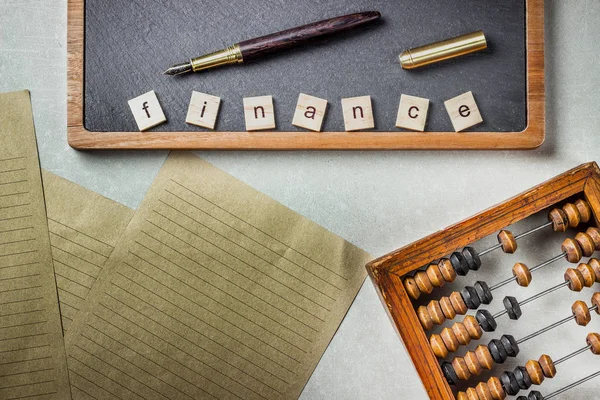 Old wooden scratched vintage decimal abacus and chalkboard on concrete background. Top view. Mock up. Copy space — Stock Photo, Image