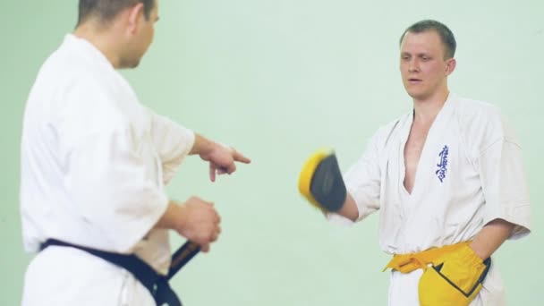 Russia, Novosibirsk, August 15, 2018 A group of people practicing karate strokes indoors. Endurance training in karate — Stock Video