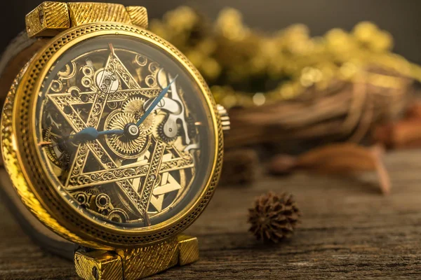 Vintage skeleton watch with Star of David on wood background