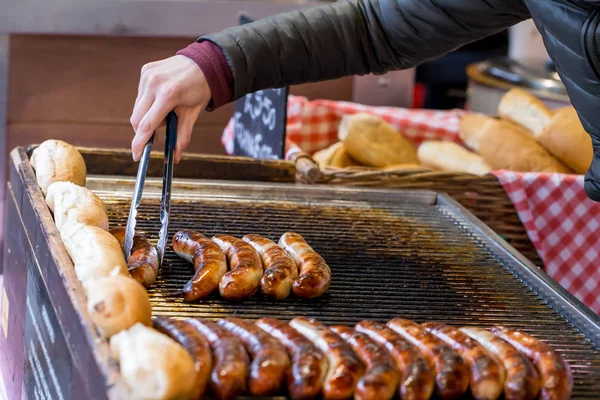 Cooking sausages on a market stall