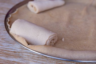 Injera is a sourdough flatbread made from teff flour.  It is the national dish of Ethiopia, Eritrea, Somalia and Djibouti clipart
