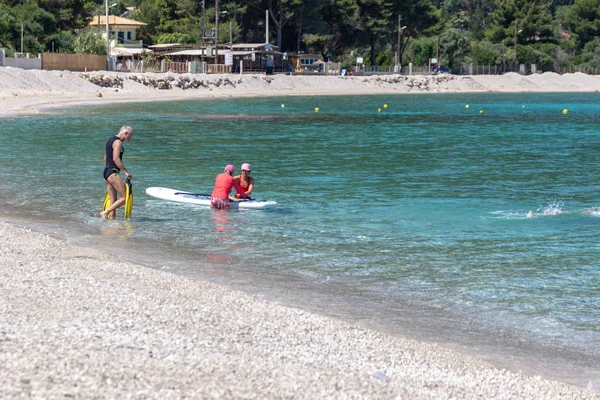 LEFKADA, GREECE - MAY 29 2018: Seniors enjoying beach based leisure activities in the sea off Agios Ioannis beach, Lefkada, Greece. — Stock Photo, Image
