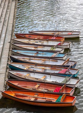 Wooden boats for hire moored on the River Thames clipart