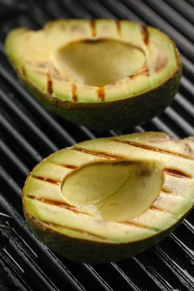 sliced fresh avocado on the grill. Health food. Barbeque avocado