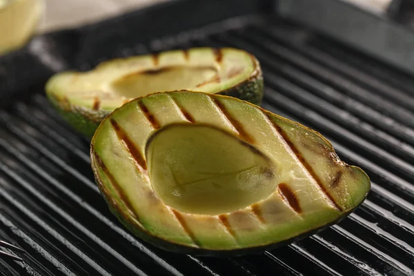 sliced fresh avocado on the grill. Health food. Barbeque avocado