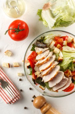 salata cesar tavuk ızgara Beyaz ahşap masa üzerinde cam kapta. Dekor taze sebze