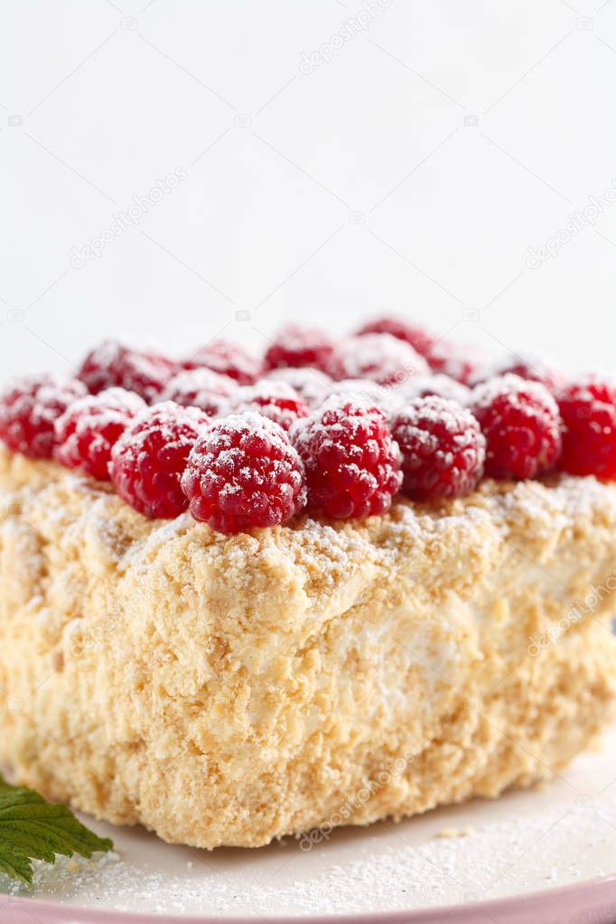 Napoleon cake with raspberry and sugar close-up