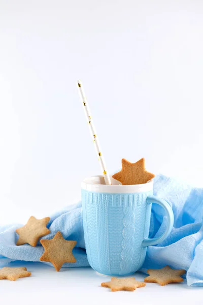 blue mug and ginger cookies on white background. Christmas composition