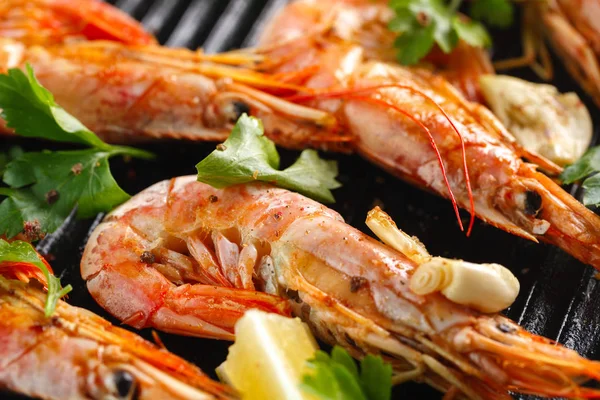 Grilled shrimps with spice and lemon. Grilled seafood. Langoustines.