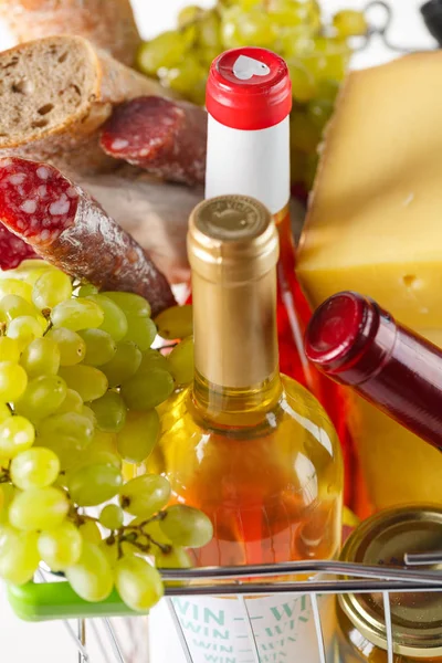 products in the basket. Salami, grapes, bread, cheese and wine closeup