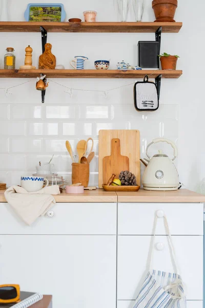 white kitchen interior. Scandinavian interior design in light colors with plants and accessories. kitchen details. Sunny day