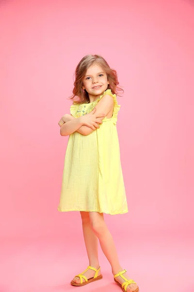 Young cute girl in yellow dress — Stock Photo, Image