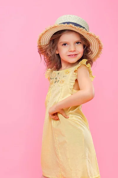 Close up portrait of a Beautiful girl in yellow dress and straw hat. — Stock Photo, Image