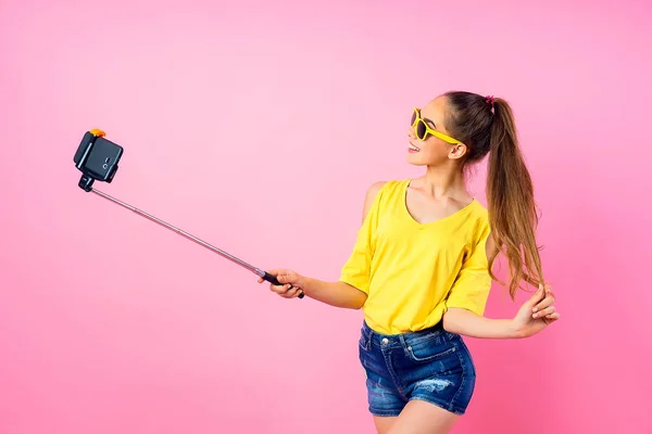 Smiling teenage girl making selfie with stick — Stock Photo, Image