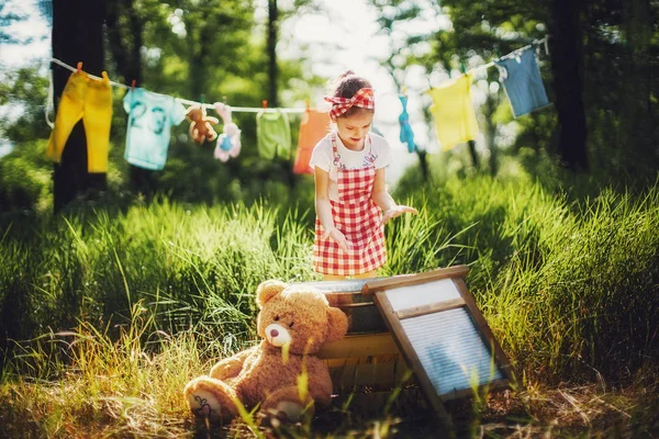 Little girl washing toys — Stock Photo, Image