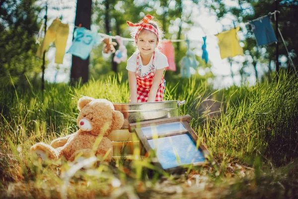 Маленька дівчинка миє іграшки — стокове фото