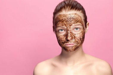Yüz cilt fırçalayın. Seksi portresi gülümseyen kadın modeli doğal kahve maskesi, uygulama yüz fırçalayın yüz cilt üzerinde. Yüzü güzel mutlu kadınla closeup güzellik ürünü ile kaplı.
