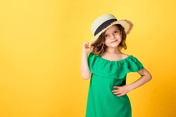 Little girl in dress and hat in studio — Stock Photo, Image