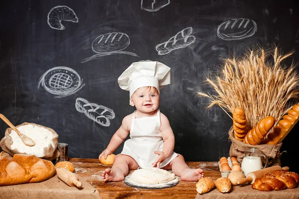 Adorable infant on table with dough Royalty Free Stock Images