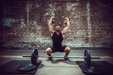 Atletik bir adam bir kettlebell ile çalışma dışarı. Güç ve motivasyon