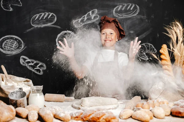 Cute boy with chef hat cooking — Stock Photo, Image