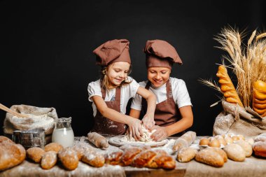 Adorable girl with brother cooking clipart