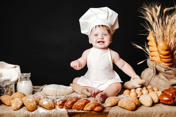 Adorable infant on table with dough Stock Image