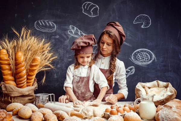 Kvinna och flicka att göra bakverk tillsammans — Stockfoto