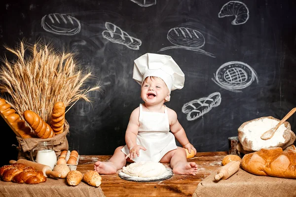 Adorable infant on table with dough Royalty Free Stock Photos