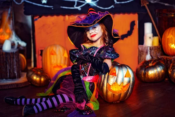 Cadılar Bayramınız Kutlu Olsun. Bir cadı kostümü, küçük bir güzel kız kabak ile kutluyor — Stok fotoğraf