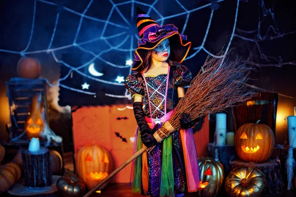 Bir cadı kostüm sihirli süpürge ile sevimli bir küçük çocuk kız portresi. — Stok fotoğraf