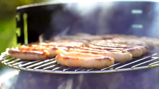 Grilled sausage on the picnic flaming grill — Stock Video