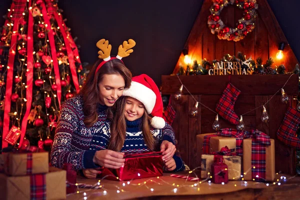 En lycklig familj mamma och barn packa julklappar — Stockfoto