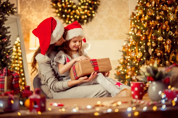 A happy family mother and child pack Christmas gifts Stock Image