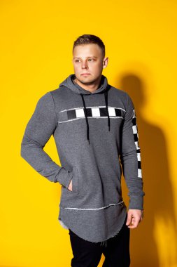 Şık yakışıklı genç moda kazaklı bir saç kesimi ile poz veriyor