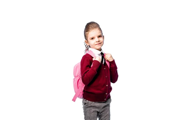 Дитина з шкільною сумкою. Дівчина в білій сорочці і сірих штанях, тримає шкільну сумку і позує як модель. Ізольовані на білому — стокове фото