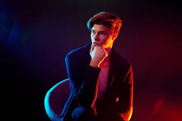 High Fashion male model in colorful bright neon lights posing on black background. Art design concept — Stock Photo, Image