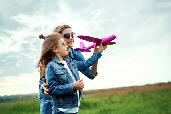 Мать и дочь играют в игрушечный самолет — стоковое фото