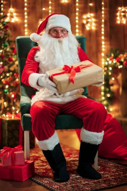 Gözlüklü mutlu Noel Baba 'nın fotoğrafı. Kameraya bakıyor.
