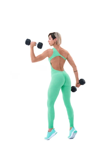 Strong woman with dumbbells. Photo of sporty woman in sportswear on white background. Back view — Stock Photo, Image