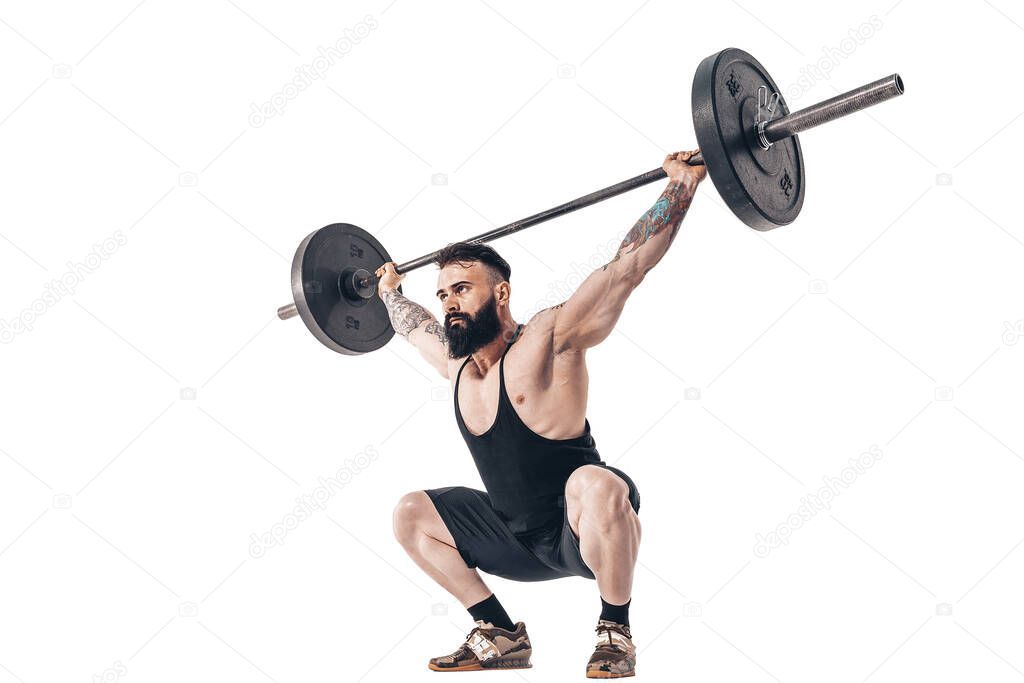 The technique of doing an exercise of deadlift with a barbell of a muscular strong tattooed bearded sports men on a white studio background. Isolate