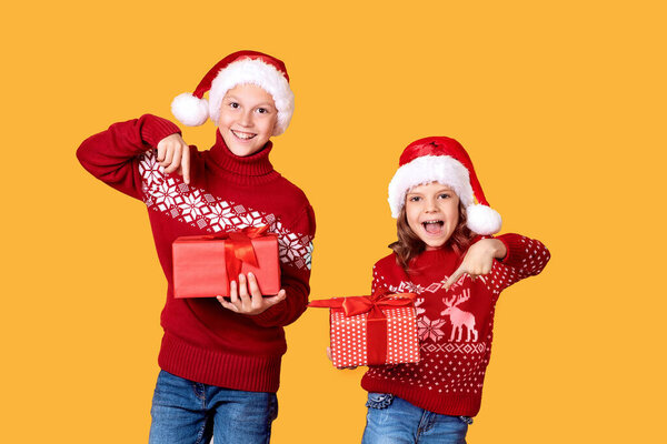 Happy children holding red gift boxes