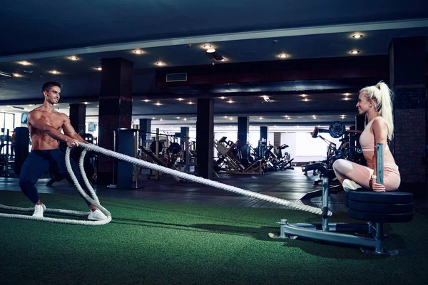 Fitness man working out with battle ropes at gym — Stock Photo, Image