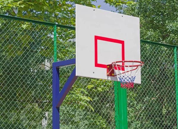 basketball backboard hoop and net in a park